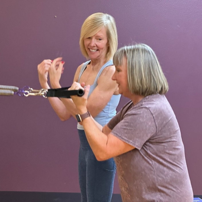 Colleen Rhodes instructing a client during a personal training session.